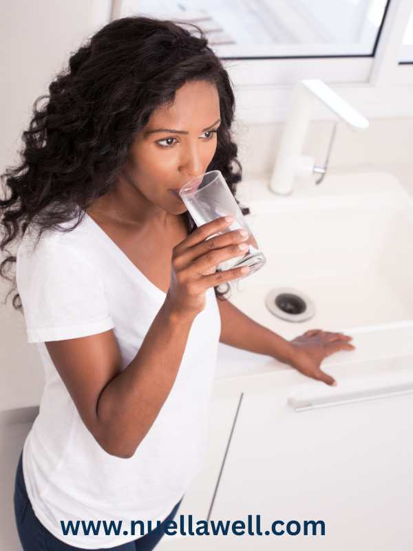 a-mom-taking-a-glass-of-water-for-everyday-wellness-for-busy-moms