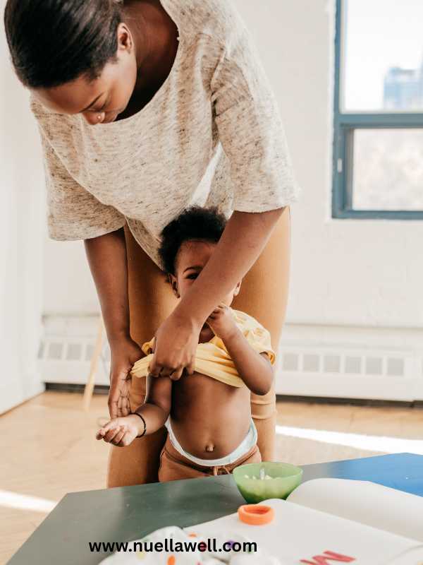 mom-feeding-and-dressing-her-kid-as-a-morning-routine