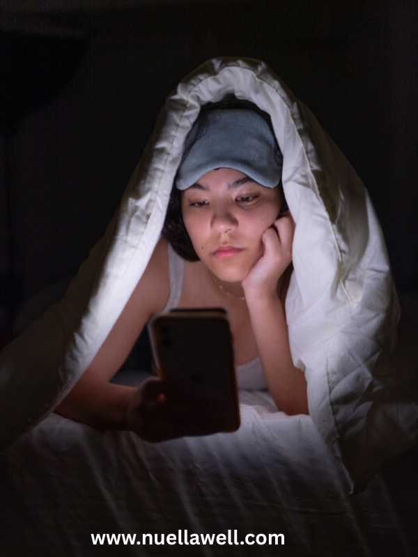 a-mom-tired-mom-on-bed-checking-her-phone-before-sleep