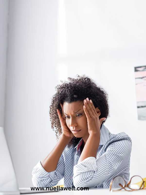 a-mom-holding-her-head-and-looking-overwhelmed