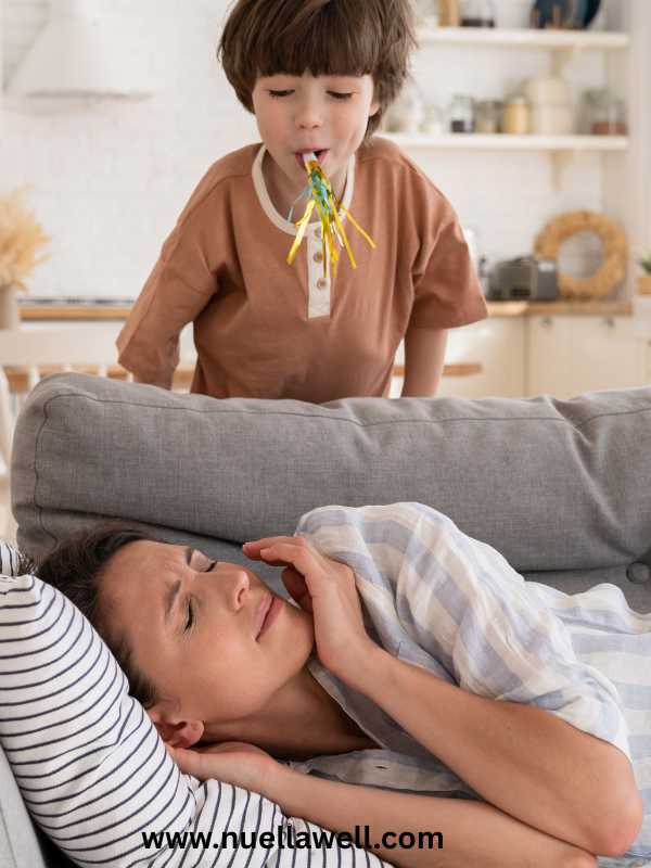 a-tired-mom-on-a-couch-with-her-kid-on-natural-ways-to-boost-energy-for-busy-moms
