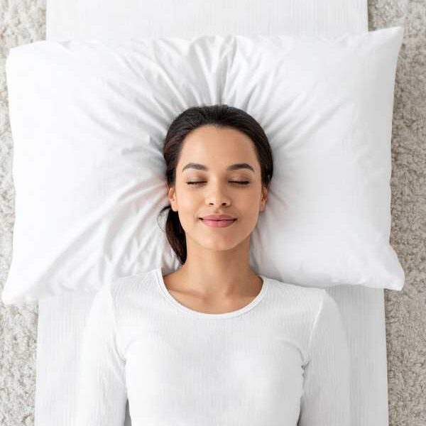 a-mom-on-white-cloth-relaxing-on bed-before-sleep-in-how-busy-moms-can-improve-sleep-naturally