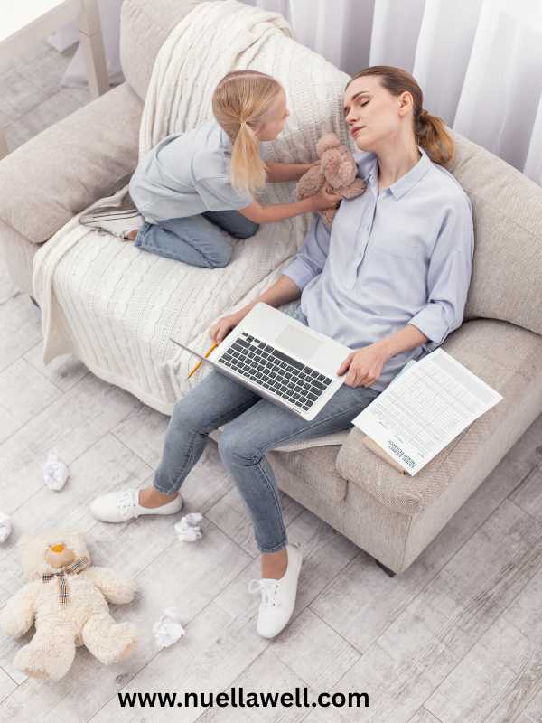 a-tired-mom-siting-quietly-with-her-kid-in-signs-of-mom-burnout-and-how-to-recover