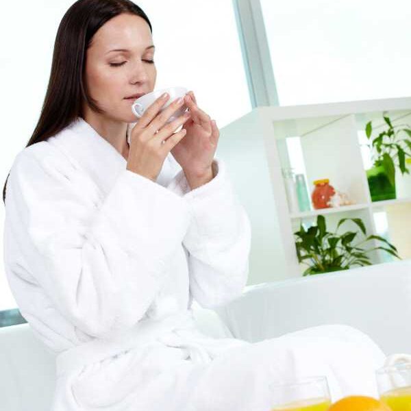 a-mom-in-a-white-robe-drinking-water-in-how-to-protect-your-energy-as-a-busy-mom