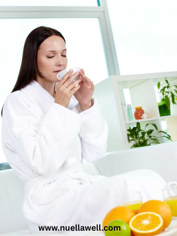 a-mom-in-a-white-robe-drinking-water-in-how-to-protect-your-energy-as-a-busy-mom