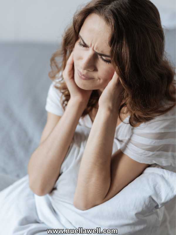 a-woman-on-white-nightie-having-low-energy-in-the-morning