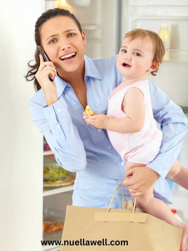 a-busy-mom-carrying-her-baby-and-working-at-the-same-time