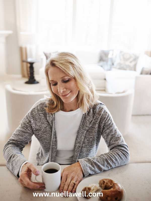 a-mom-seated-calmly-with-a-cup-of-tea-thinking-in-how-to-protect-your-energy-as-a-busy-mom