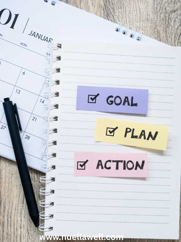 a-book-containing-written-down-goals-in-how-to-achieve-realistic-goals-as-a-busy-mom