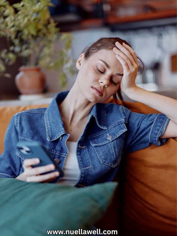 a-woman-holding-her-head-and-looking-drained
