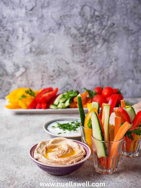 carrots-and-cucumber-sticks-in-a-plate-with-a-plate-of-hummus