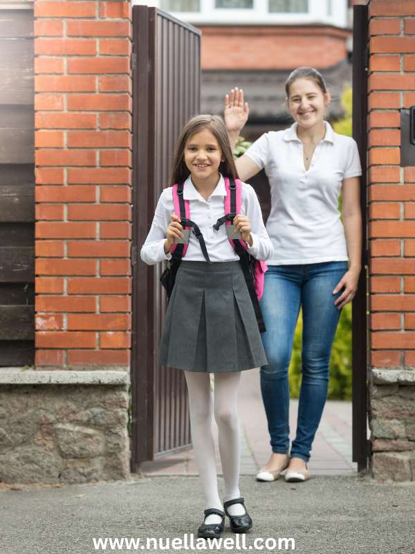 A-happy-child-leaving-home-with-a-backpack-while-a-mom-smiles-at-the-front-door.