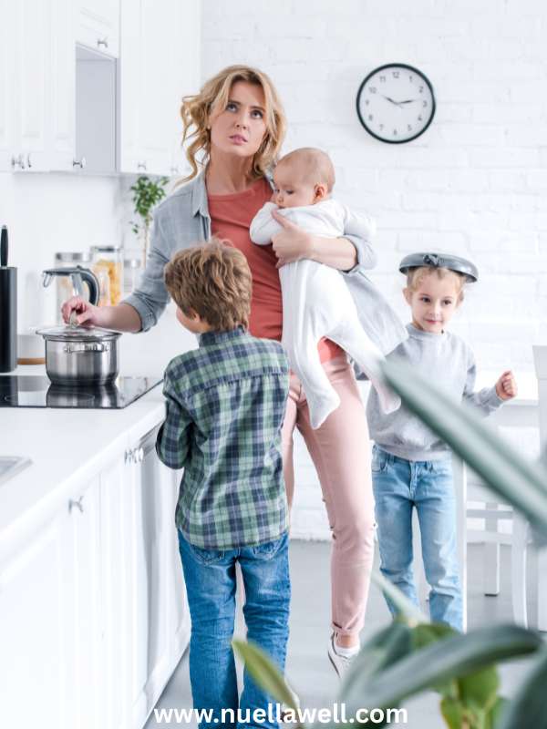 Mom-in-the-kitchen-cooking-with-her-kids-in-summer-burnout-for-moms-during-school-break