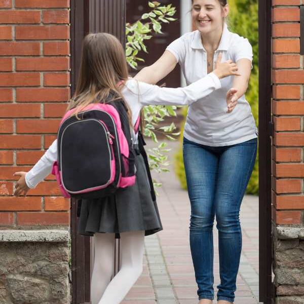 busy-mom-welcoming-child-home-after-school-routine
